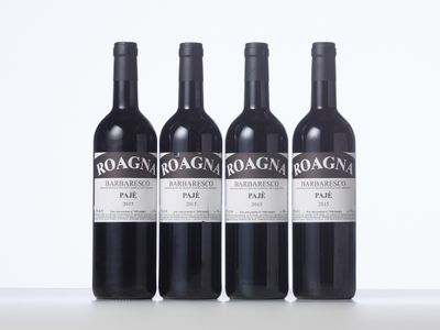 three bottles of red wine are lined up on a table