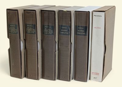 five books that are stacked on top of each other