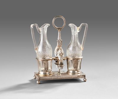 two glass vases on a stand with a key in the middle