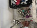 many different kitchen utensils in a plastic container