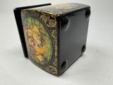 a small black box with a painting on it