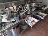 many pots and pans on the kitchen counter