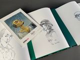 an open book with a drawing of a man and a woman on it