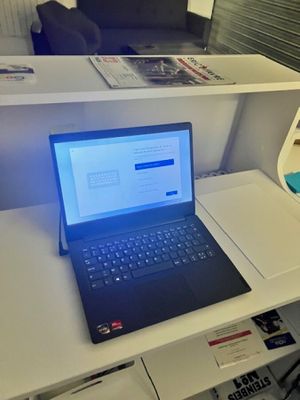 a laptop computer sitting on a desk in front of a tv