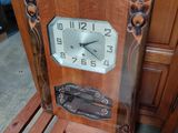 a wooden chair with a clock on the back of it