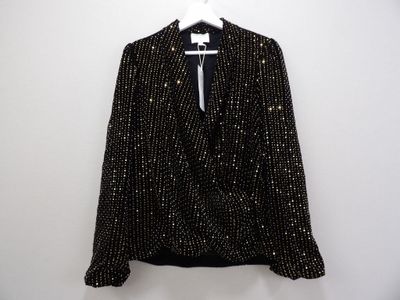 a black and white jacket hanging on a white hanger