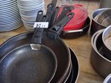 many pans and pans sitting on a table in a kitchen