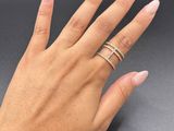 a woman ' s hand with a gold ring on her finger