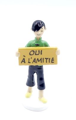 a figurine of a boy holding a sign that says oh al amitie