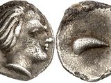 a silver coin with a man ' s face and a woman ' s face