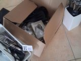 a box of silverware on the floor next to a container of forks and spoons