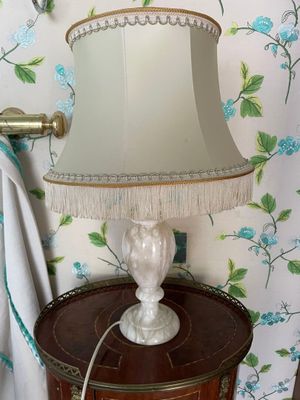 a lamp that is sitting on a table in a room
