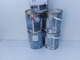 several cans of paint are stacked on top of each other