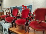 four red chairs sitting on top of a wooden table