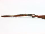 an old rifle with a wooden barrel and a metal handle