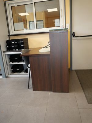 a desk with a mirror and a chair in a room