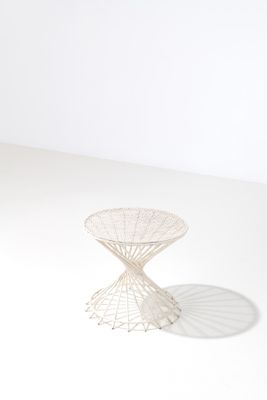an image of a white table with a wire design on top of it