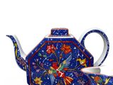 a blue teapot and a cup sitting next to each other