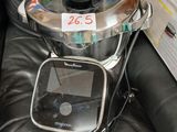 a black leather chair with a metal pot on top of it