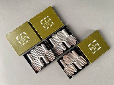 three boxes of silverware sitting next to each other on a table