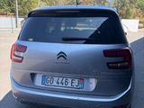 the rear of a silver citrole parked in a parking lot