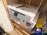 a printer that is sitting on top of a cabinet