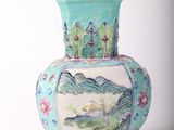 a blue vase with a painting on it sitting on a table