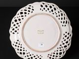 a white plate with a lacy design on it