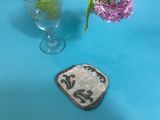 a glass of water and a small patch on a table