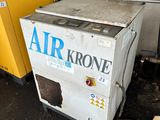 two air dryers sitting next to each other in a garage