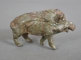 a small statue of a bull that is standing on a table