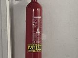 a red fire extinguisor hanging on the wall