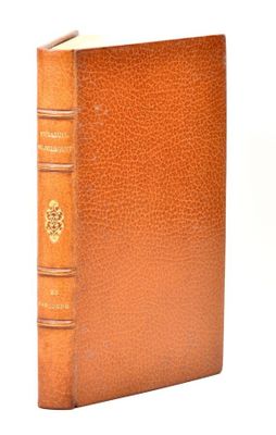an old book with a brown leather cover sitting on a white surface