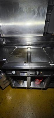 two stainless steel sinks in the middle of a kitchen