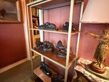 a shelf with shoes on it in the corner of a room