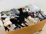 many pairs of shoes in a box on the floor