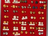 a red display case with a lot of coins on it