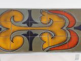 a tile table with a design on the top