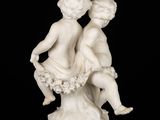 an image of a statue of two children sitting on a tree stump
