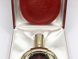 an image of a red leather case with a perfume bottle in it