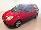 a red car parked in a garage with a white floor