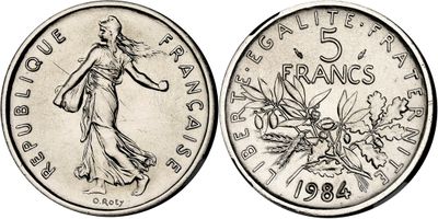 a close up of a coin with a woman on it