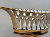 a silver and gold glass bowl on a stand