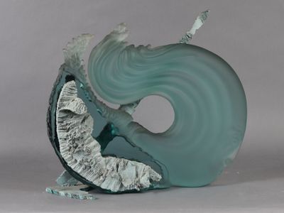 a glass sculpture of a woman on a wave