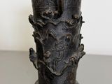 a black vase sitting on top of a table
