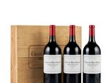 three bottles of wine in front of a wooden box
