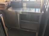 a stainless steel counter with a bunch of plates on it