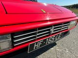 a close up of a red sports car parked in a parking lot