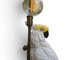 a bird that is sitting on top of a lamp