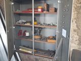 a metal cabinet that is open in the corner of a room
